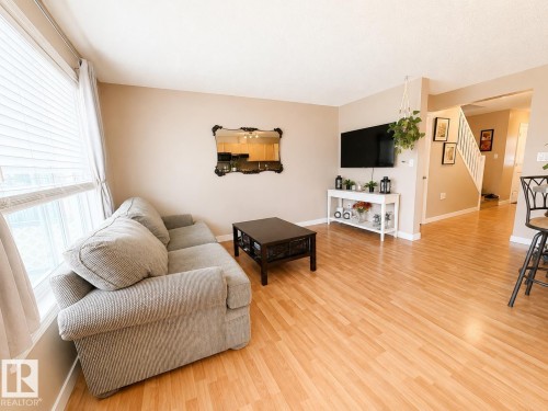 Bright living area with light wood-finish flooring - 21207 90 Ave Nw, Edmonton, AB - Indoor Photo Showing Living Room