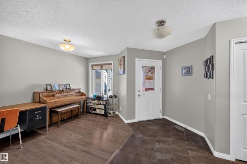 Recessed window, wood-finish flooring, white paneled doors, and two flush mount light fixtures - 16515 139 Street Nw, Edmonton, AB - Indoor Photo Showing Other Room