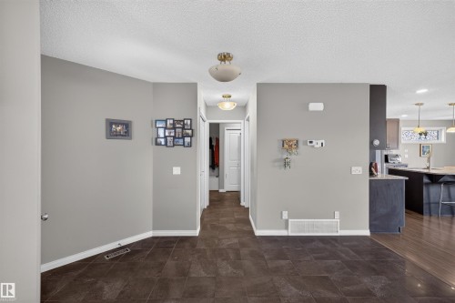 Porcelain tile flooring, wood-finish flooring, recessed lighting, ceiling-mounted light fixtures, built-in cabinetry - 16515 139 Street Nw, Edmonton, AB - Indoor Photo Showing Other Room