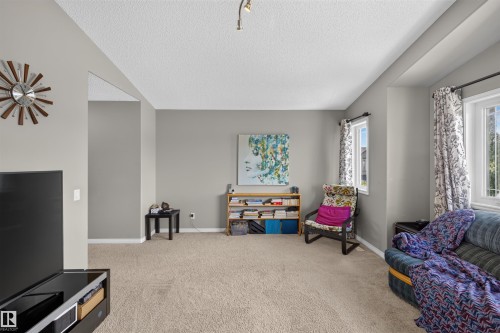 Recessed windows with window treatments, textured ceiling, light-toned carpeting, and track lighting - 16515 139 Street Nw, Edmonton, AB - Indoor