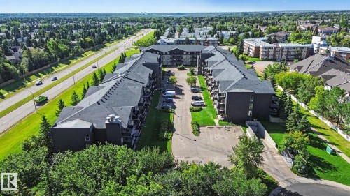 Multi-story residential buildings with dark exteriors and dark sloped roofs - #226 17011 67 Av Nw, Edmonton, AB - Outdoor With View