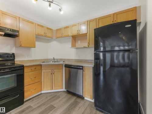 #216 111 Edwards Dr Sw, Edmonton, AB - Indoor Photo Showing Kitchen With Double Sink