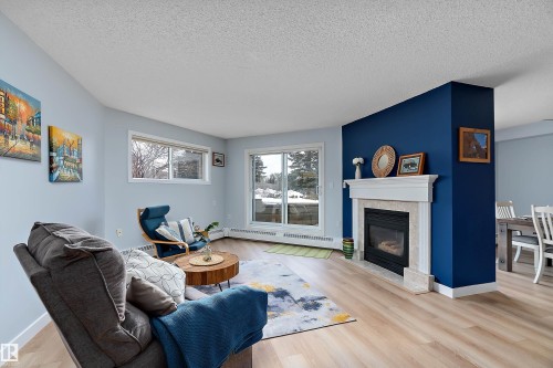 #124 15499 Castle Downs Rd Nw, Edmonton, AB - Indoor Photo Showing Living Room With Fireplace