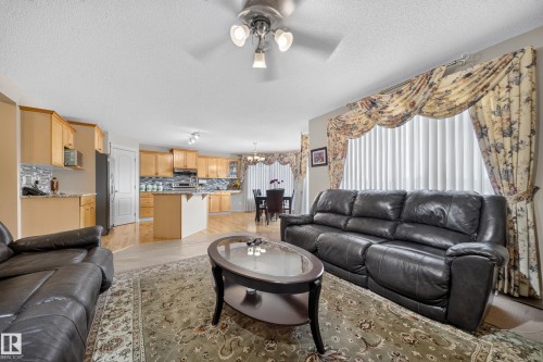 Open-concept living space featuring wood-finish flooring, recessed lighting, a ceiling fan, and ample natural light - 2518 33A Avenue Nw, Edmonton, AB - Indoor Photo Showing Living Room