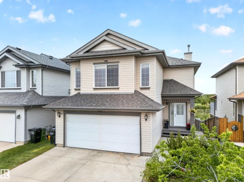 Two-story home with light-colored siding, a dark shingle roof, and a prominent front-facing gable - 2518 33A Avenue Nw, Edmonton, AB - Outdoor With Facade