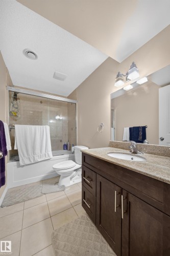Expansive vanity with a stone countertop and an undermount sink - 2518 33A Avenue Nw, Edmonton, AB - Indoor Photo Showing Bathroom
