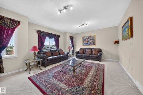 Spacious room featuring multiple windows, neutral wall tones, and recessed lighting - 2518 33A Avenue Nw, Edmonton, AB - Indoor Photo Showing Living Room