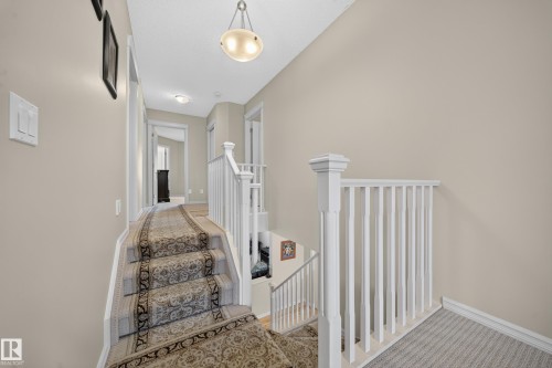 Staircase with carpet runner, white balusters, and a recessed ceiling light fixture - 2518 33A Avenue Nw, Edmonton, AB - Indoor Photo Showing Other Room