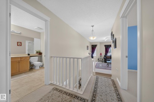 Hallway with white railing, recessed lighting, and a ceiling-mounted light fixture - 2518 33A Avenue Nw, Edmonton, AB - Indoor Photo Showing Other Room