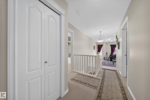 White paneled bi-fold doors, neutral wall paint, and light carpeting create a cohesive interior design - 2518 33A Avenue Nw, Edmonton, AB - Indoor Photo Showing Other Room