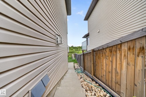 Concrete pathway bordered by decorative stone landscaping - 2518 33A Avenue Nw, Edmonton, AB - Outdoor With Exterior
