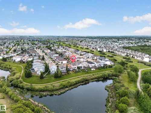 Residential neighborhood with a prominent water feature and surrounding green spaces - 2518 33A Avenue Nw, Edmonton, AB - Outdoor With Body Of Water With View