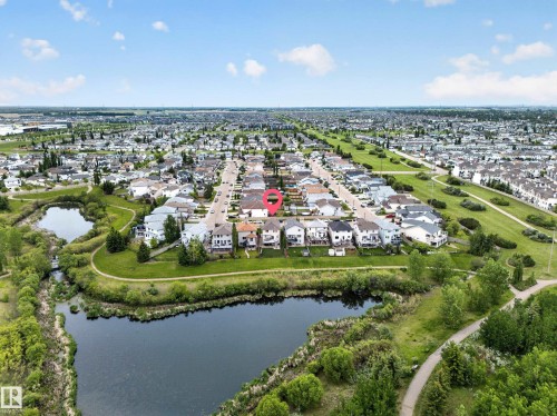 Residential neighborhood with a prominent street, surrounding green spaces, and a body of water - 2518 33A Avenue Nw, Edmonton, AB - Outdoor With Body Of Water With View