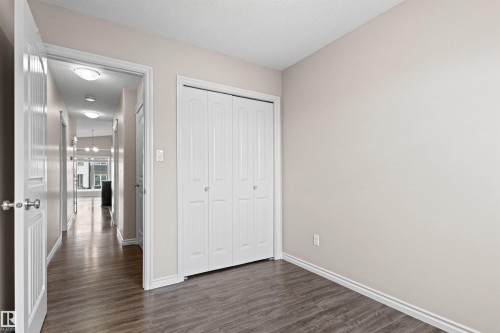 Room featuring wood-finish flooring, light neutral wall paint, and white trim - 10634 155 Street Nw, Edmonton, AB - Indoor Photo Showing Other Room