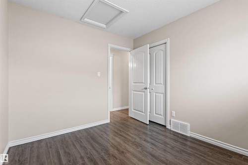 Room featuring wood-finish flooring, white baseboards, and a neutral wall color - 10634 155 Street Nw, Edmonton, AB - Indoor Photo Showing Other Room