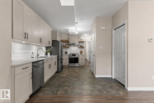 This is a possible rendering of the basement kitchen which has roughed in plumbing to create this kitchen layout. - 10634 155 Street Nw, Edmonton, AB - Indoor Photo Showing Kitchen With Upgraded Kitchen