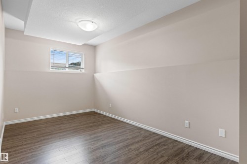 Room featuring wood-finish flooring, neutral wall tones, and white trim - 10634 155 Street Nw, Edmonton, AB - Indoor Photo Showing Other Room