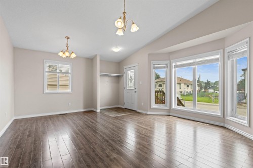 Spacious interior with wood-finish flooring, vaulted ceiling, and neutral wall tones - 10634 155 Street Nw, Edmonton, AB - Indoor