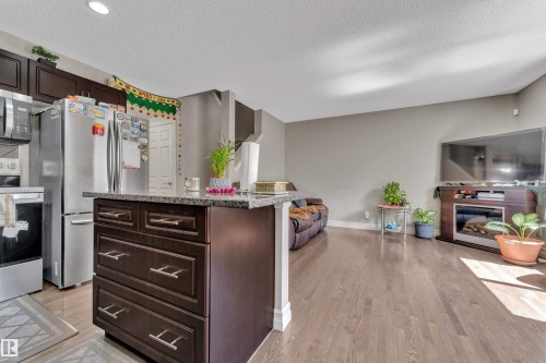 #24 655 Tamarack Rd Nw, Edmonton, AB - Indoor Photo Showing Kitchen With Fireplace