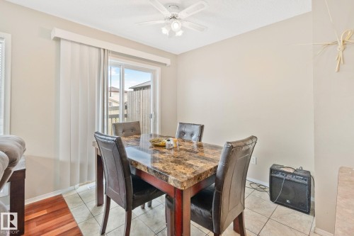 Dining area featuring a sliding glass door, overhead ceiling fan, and ceramic tile flooring - 3769 21 Street Nw, Edmonton, AB - Indoor Photo Showing Dining Room