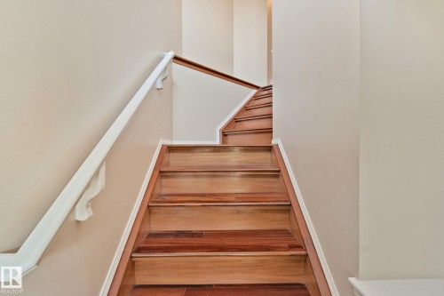 Hardwood staircase with light wood-finish treads and risers - 3769 21 Street Nw, Edmonton, AB - Indoor Photo Showing Other Room