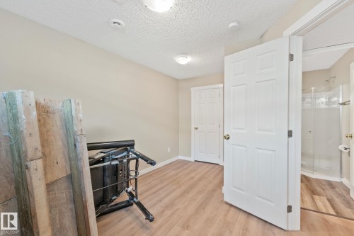 Room featuring wood-finish flooring, neutral wall paint, and white trim - 3769 21 Street Nw, Edmonton, AB - Indoor Photo Showing Other Room