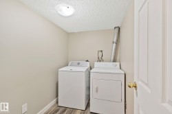 Dedicated laundry area with a top-load washer and front-load dryer - 