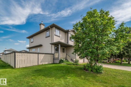 Two-story property featuring light-toned siding and a prominent chimney - 3769 21 Street Nw, Edmonton, AB - Outdoor