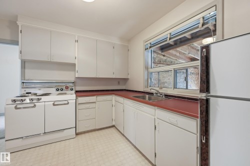 Well kept kitchen with lots of space. Great shape or make it your own. Large window looking into back patio area. - 10935 127 Street Nw, Edmonton, AB - Indoor Photo Showing Kitchen