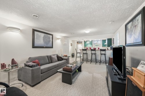 Includes spacious living area, 4 piece bathroom, kitchen with workable counter space and a high chair bar. - 10935 127 Street Nw, Edmonton, AB - Indoor Photo Showing Living Room
