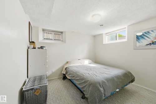 Bedroom with sliding mirror closet - 10935 127 Street Nw, Edmonton, AB - Indoor Photo Showing Bedroom