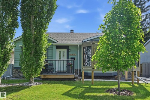 Front of house. Custom built wall, tastefully landscaped with large trees for added privacy. - 10935 127 Street Nw, Edmonton, AB - Outdoor