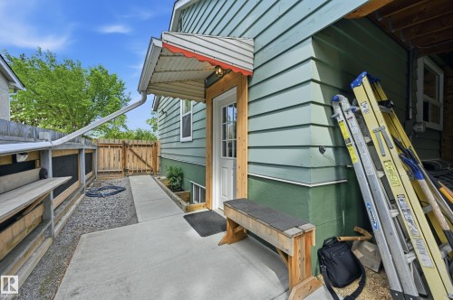 Exterior side entrance/separate entrance for basement suite with paved sidewalk spanning from front of house through to the back/garage. - 10935 127 Street Nw, Edmonton, AB - Outdoor With Exterior