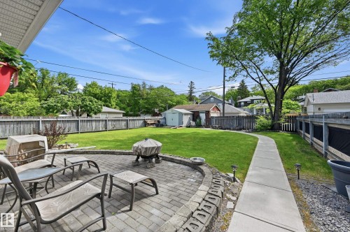 Landscaped backyard with tasteful brick patio for enjoying summer days or nighttime fires - 10935 127 Street Nw, Edmonton, AB - Outdoor