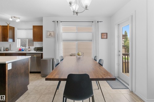 Kitchen area featuring wood-finish cabinetry, stainless steel appliances, and a central island with a light-toned countertop - 6515 37 Avenue, Beaumont, AB - Indoor