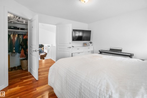 Hardwood flooring, recessed closet, white paneled doors, white walls, and a ceiling-mounted light fixture - 6515 37 Avenue, Beaumont, AB - Indoor Photo Showing Bedroom