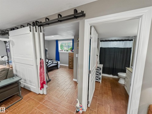 Wood-look flooring and a white vanity with a rectangular sink - 6515 37 Avenue, Beaumont, AB - Indoor