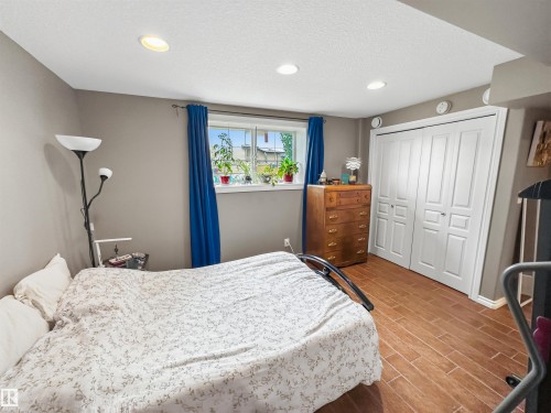 Recessed lighting, wood-finish flooring, and a large window - 6515 37 Avenue, Beaumont, AB - Indoor Photo Showing Bedroom