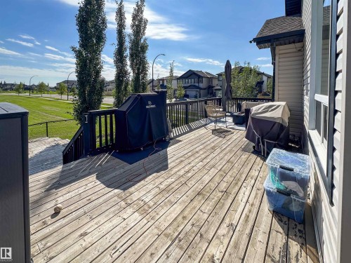 Spacious outdoor deck with wood flooring and dark wood railing - 6515 37 Avenue, Beaumont, AB - Outdoor With Deck Patio Veranda With Exterior