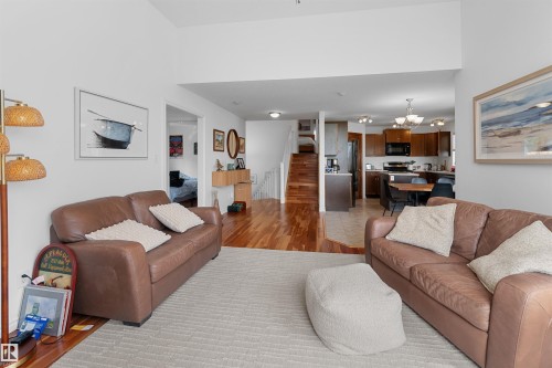 Spacious living area with wood-finish flooring, recessed lighting, and a neutral color palette - 6515 37 Avenue, Beaumont, AB - Indoor Photo Showing Living Room