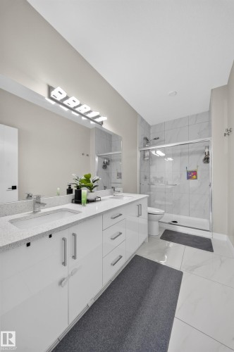 Dual vanity with integrated sinks and quartz countertops - 4301 38 St, Beaumont, AB - Indoor Photo Showing Bathroom
