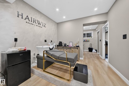 Recessed lighting illuminates the space, featuring light wood-finish flooring and neutral-toned walls - 4301 38 St, Beaumont, AB - Indoor
