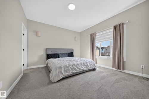 Recessed lighting fixture, light gray wall color, wall-mounted sconces, and gray carpeting - 4301 38 St, Beaumont, AB - Indoor Photo Showing Bathroom