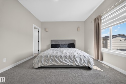 Neutral wall paint, plush carpeting, dual-pane window, and recessed lighting - 4301 38 St, Beaumont, AB - Indoor Photo Showing Bathroom