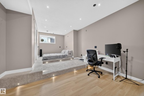 Recessed lighting, wood-finish flooring, and a carpeted raised platform with integrated lighting - 4301 38 St, Beaumont, AB - Indoor