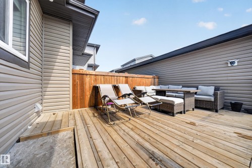 Spacious outdoor deck featuring wood planking, privacy fencing, and exterior vinyl siding - 4301 38 St, Beaumont, AB - Outdoor With Deck Patio Veranda With Exterior
