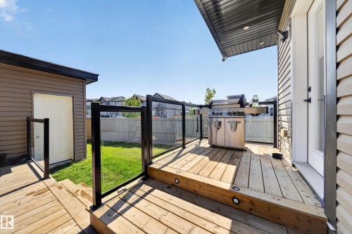 Multi-level wood-plank deck with recessed lighting and glass panel railing - 4301 38 St, Beaumont, AB - Outdoor With Deck Patio Veranda With Exterior