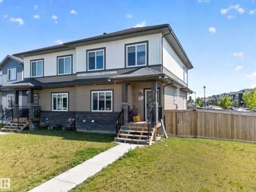 Two-story exterior with multi-toned siding and stone detailing - 4301 38 St, Beaumont, AB - Outdoor With Deck Patio Veranda