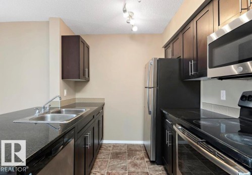 #421 3315 James Mowatt Tr Sw, Edmonton, AB - Indoor Photo Showing Kitchen With Stainless Steel Kitchen With Double Sink