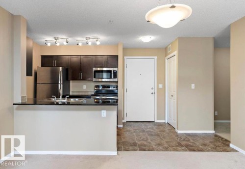 #421 3315 James Mowatt Tr Sw, Edmonton, AB - Indoor Photo Showing Kitchen With Stainless Steel Kitchen With Double Sink